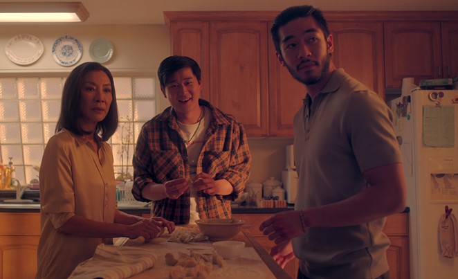 FUN WITH THE SUNS: Michelle Yeoh stars as Eileen “Mama” Sun, the matriarch of a Chinese Triad gang, whose two sons, Bruce (Sam Song Li, center), and Charles (Justin Chien), couldn’t be more different, in the bingeable new Netflix series, The Brothers Sun.