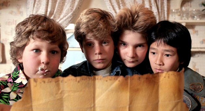 GOONIES NEVER SAY DIE! Left to right: Chunk (Jeff Cohen), Mikey (Sean Astin), Mouth (Corey Feldman), and Data (Ke Huy Quan) embark on a search for hidden treasure, in the 1985 comedy adventure The Goonies, screening July 20, in the Bay Theatre.