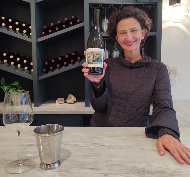 BEHIND THE BOTTLES: General Manager Vilma Mazaite stands behind the bar of Donnachadh Family Wines’ new tasting room in downtown Los Olivos.