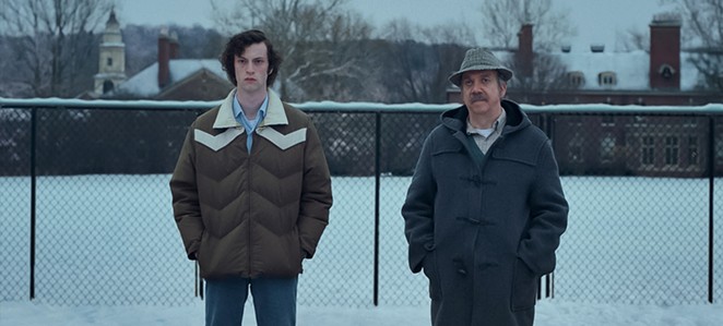 ALONE TOGETHER: After his newly remarried mother informs him their holiday is canceled, boarding school student Angus Tully (Dominic Sessa, left) is forced to spend the Christmas with his history teacher, Mr. Hunham (Paul Giamatti), in The Holdovers, screening in local theaters.