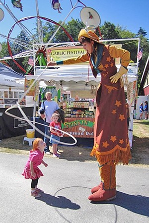 Stilt walker entertains kids of all ages at Santa Maria's Strawberry Festival